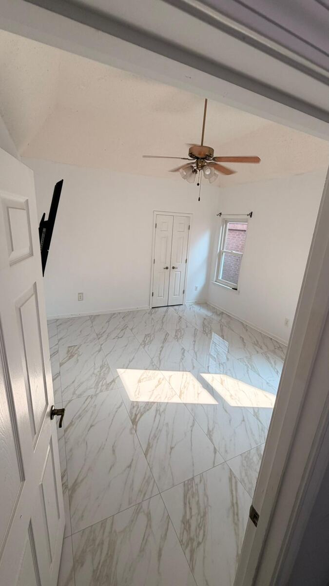 Marble-look tile flooring in a bedroom