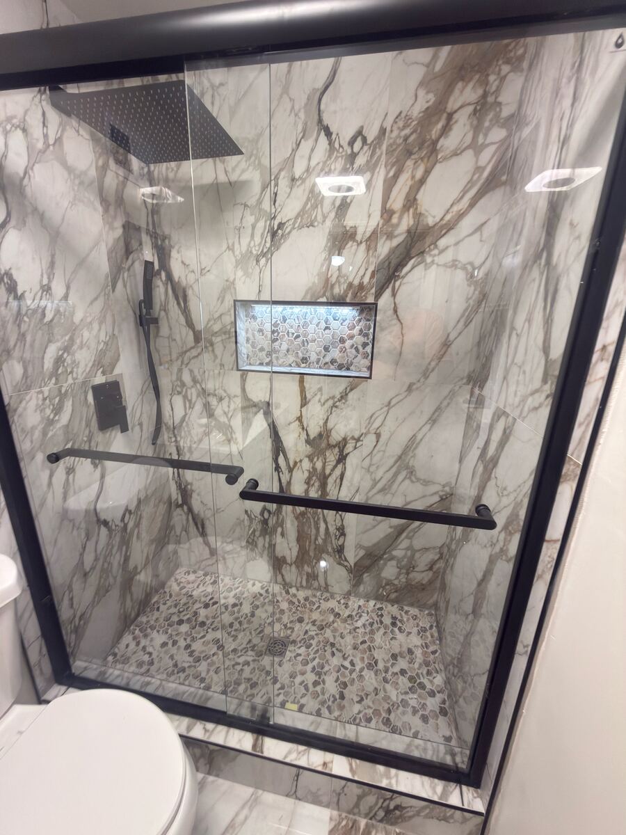 Marble shower installation with black fixtures