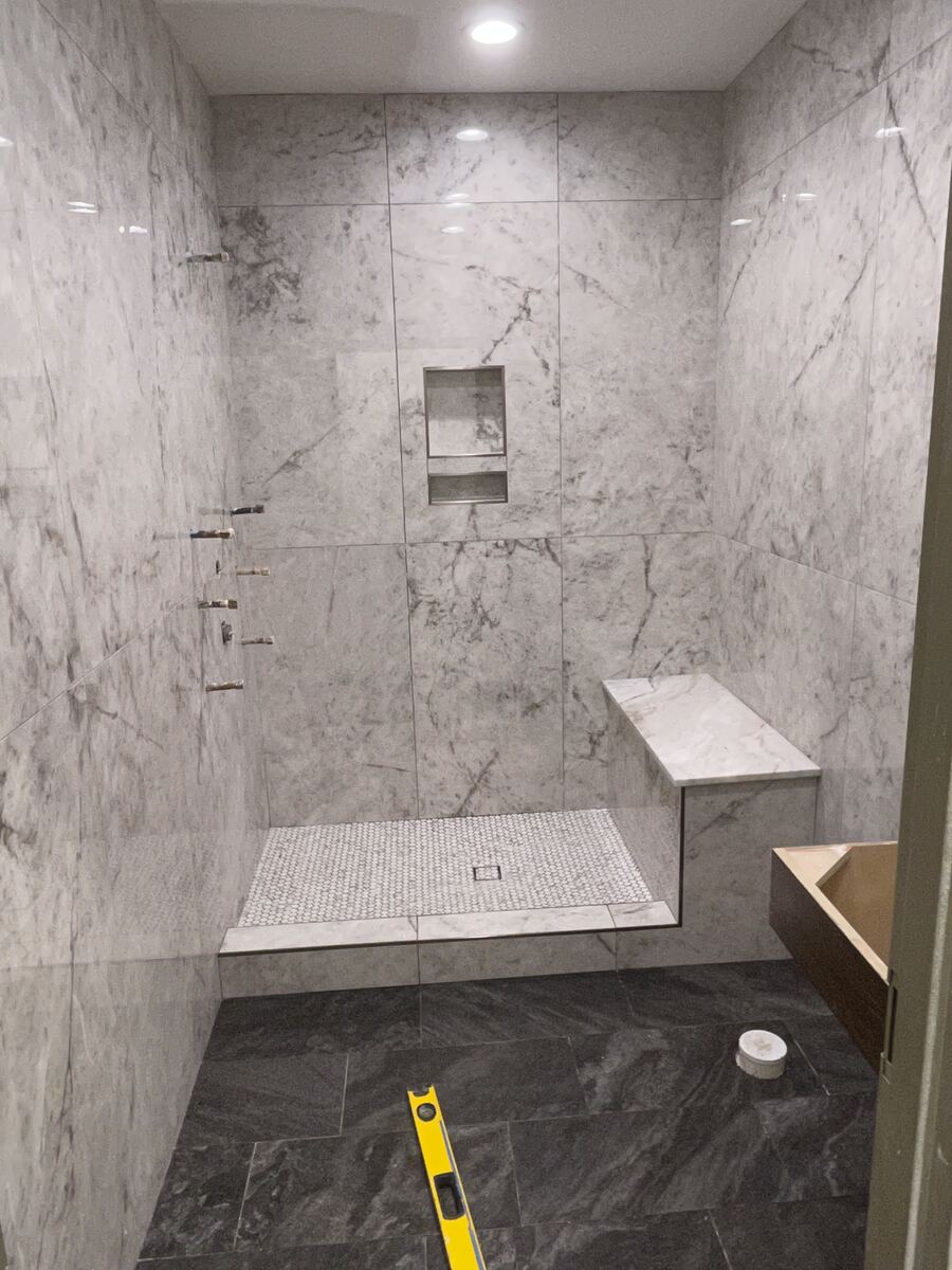 Marble tile shower with built-in bench
