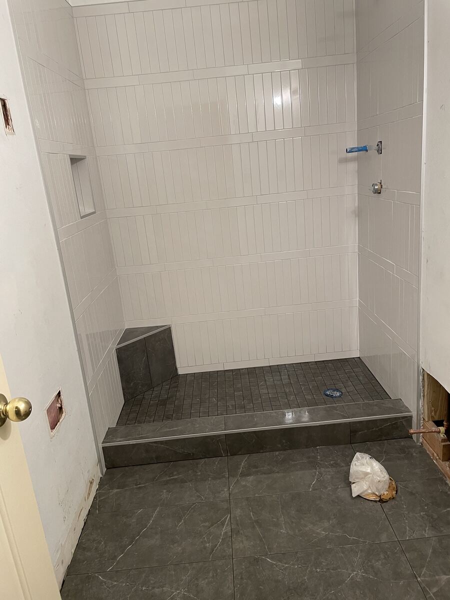 White tile shower with built-in bench